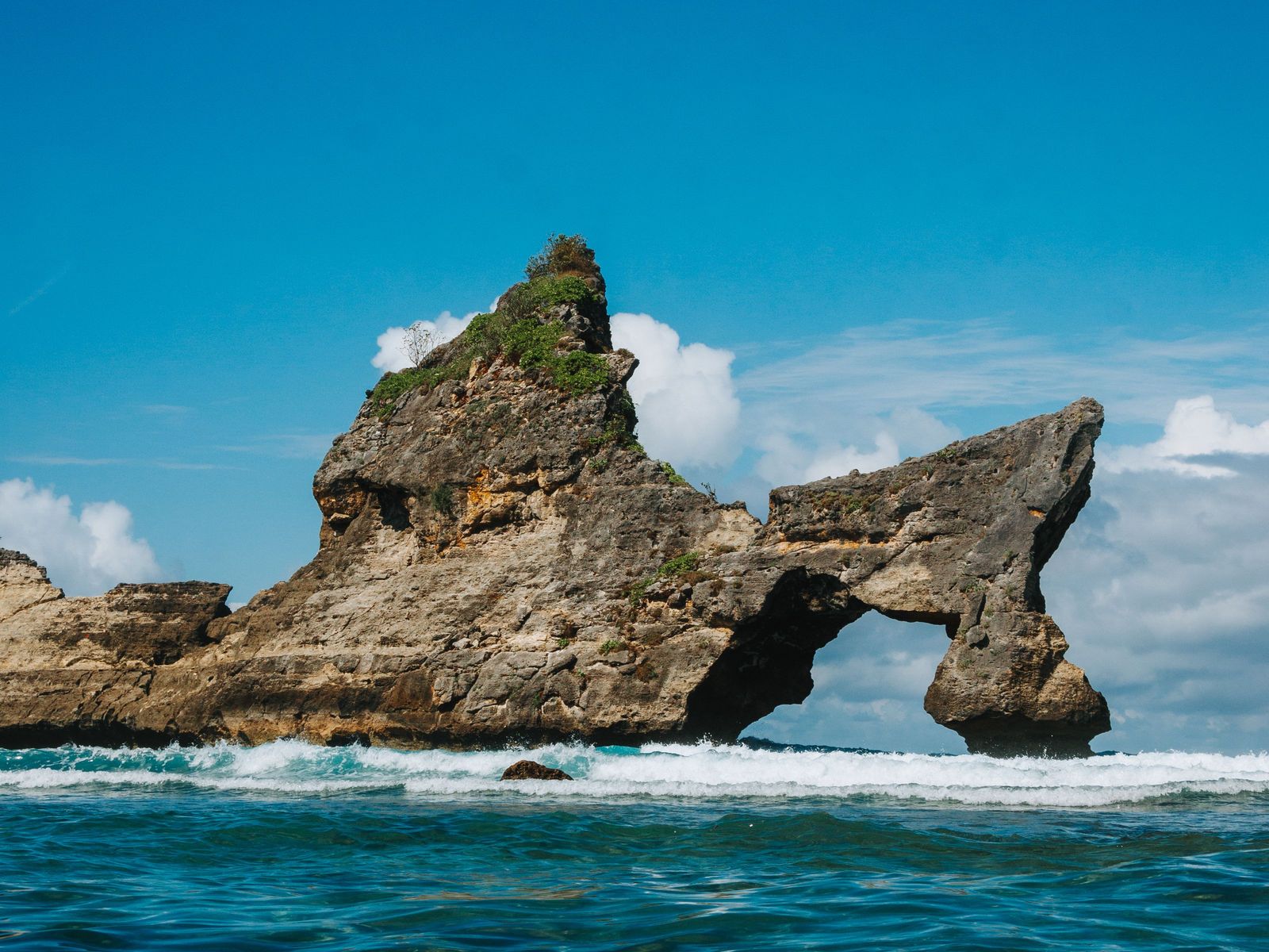The rock arch off Atuh Beach