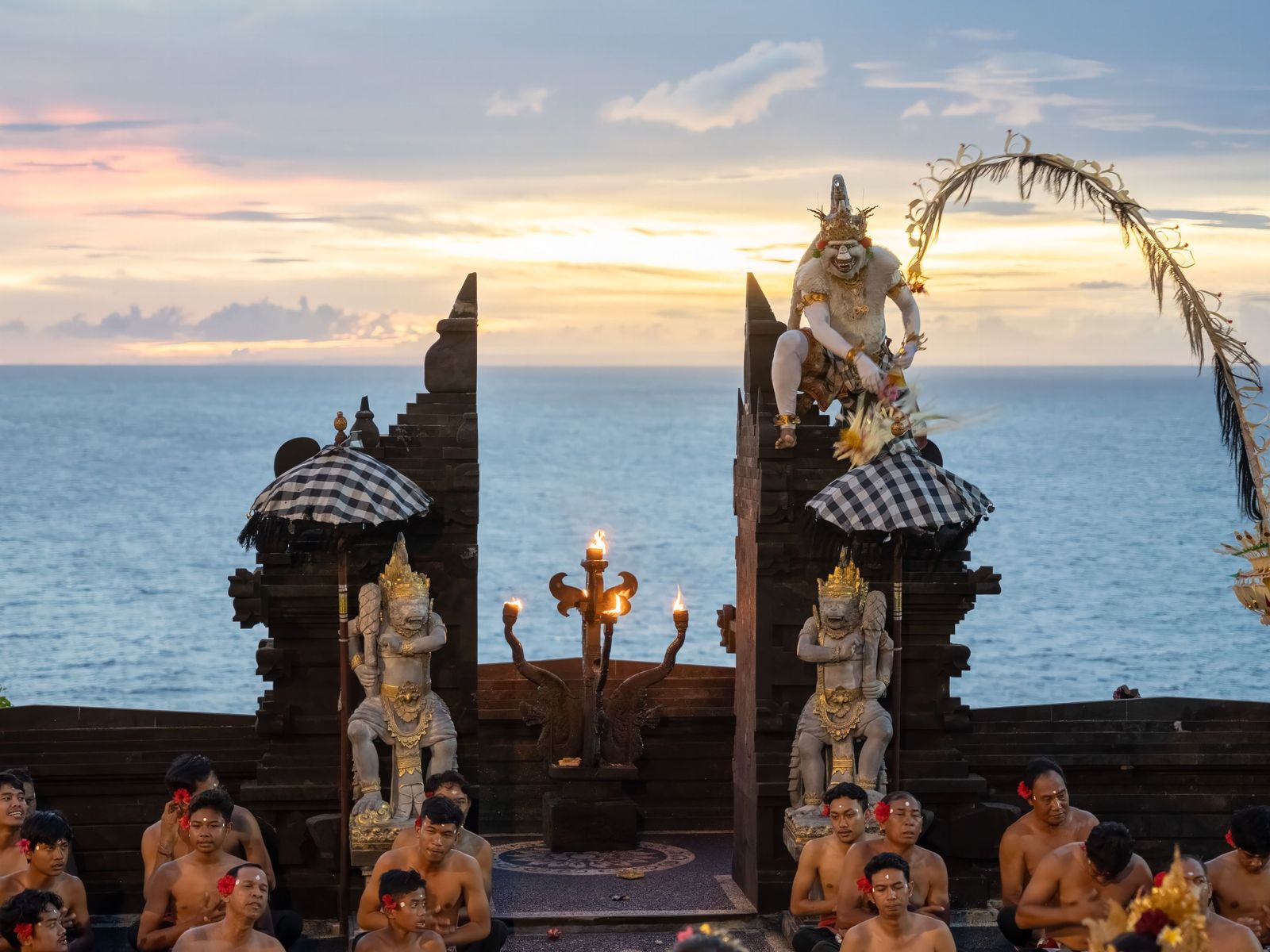 Kecak performers at Uluwatu, the sunset behind them