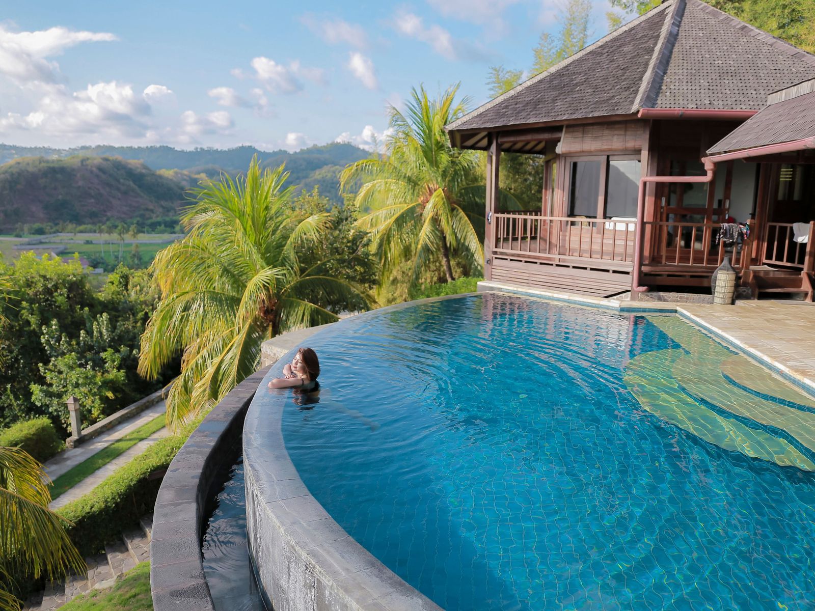 A pool looking out over hills and rice country