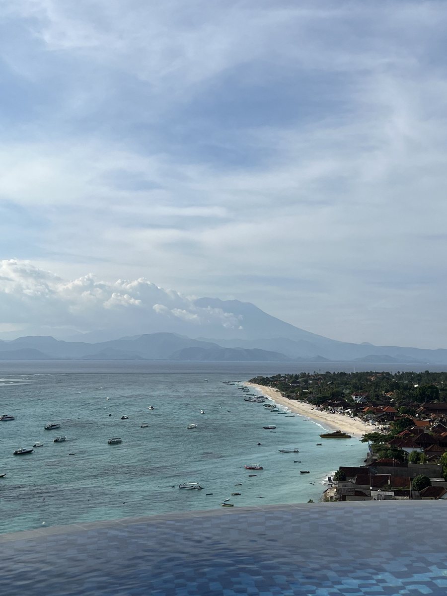 Boats moored off Nusa Lembongan, with the mountains of Bali beyond